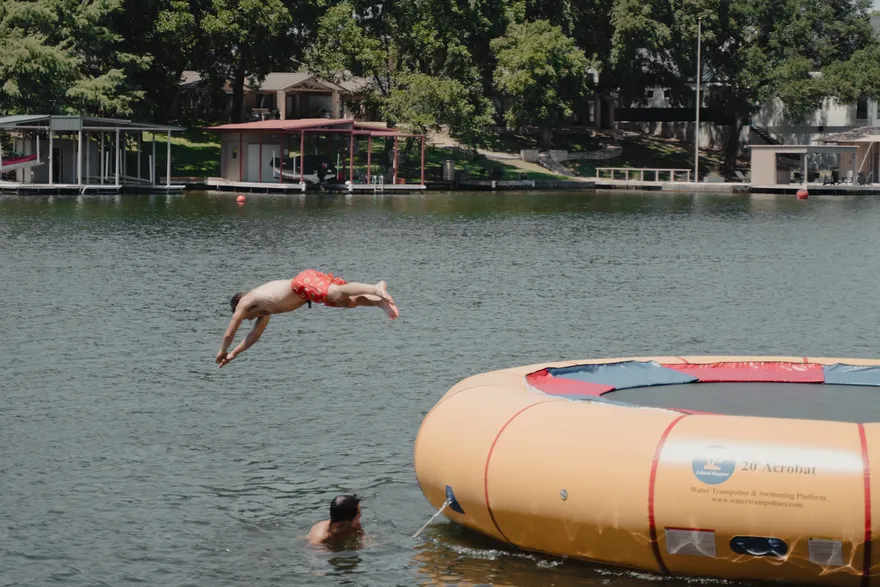 A member of the 2026 cohort jumping into the lake during retreat free time