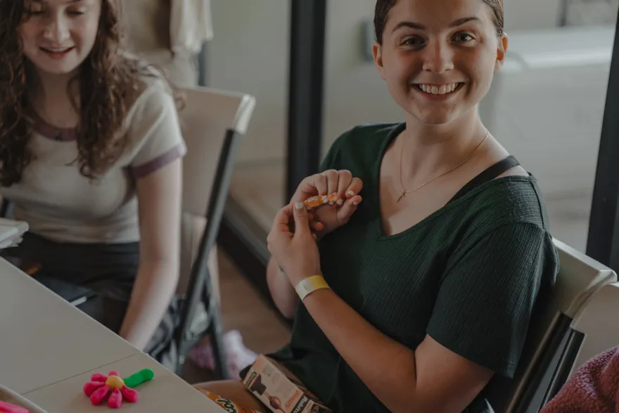 Members of the 2026 cohort making small prototypes together at a table