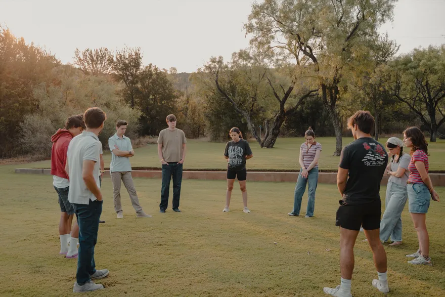 The 2026 LeapYear cohort gathered in a circle on the retreat lawn