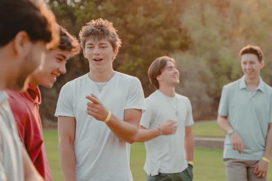 Members of the 2026 LeapYear cohort laughing together during an outdoor retreat activity