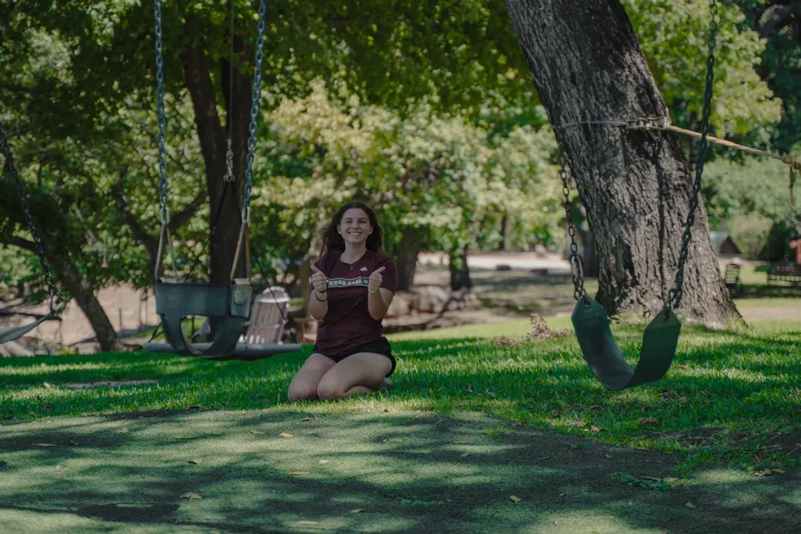 A 2026 LeapYear student reading beneath a tree on the retreat grounds