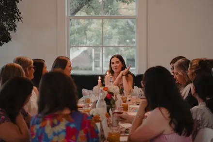 Guests gathered around the table for an Exemplar Dinner with Claire Scott