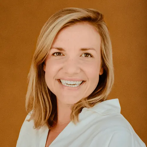 Haley Robison Dake smiling in a dark blazer