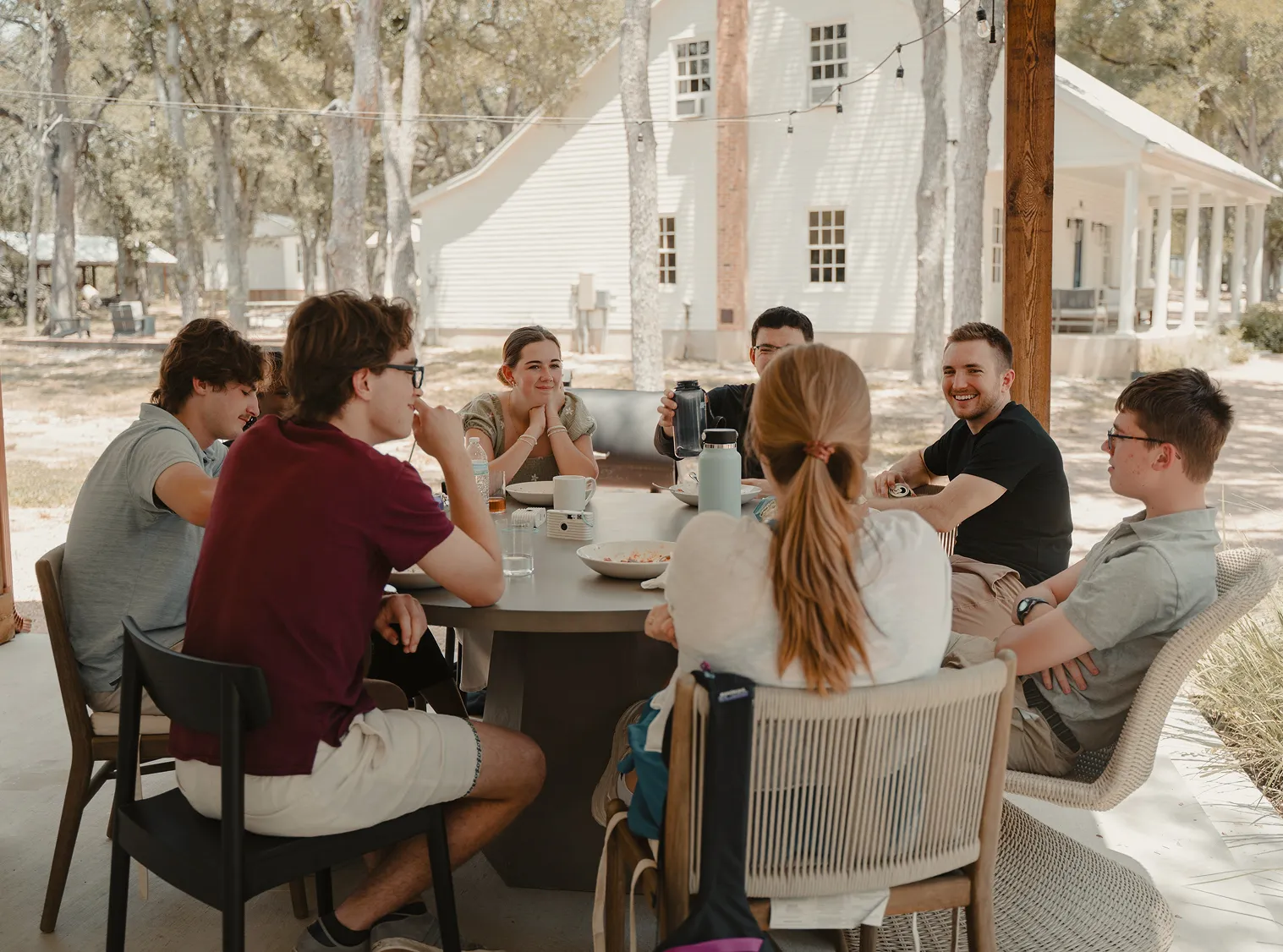 LeapYear students and coaches talking around a table