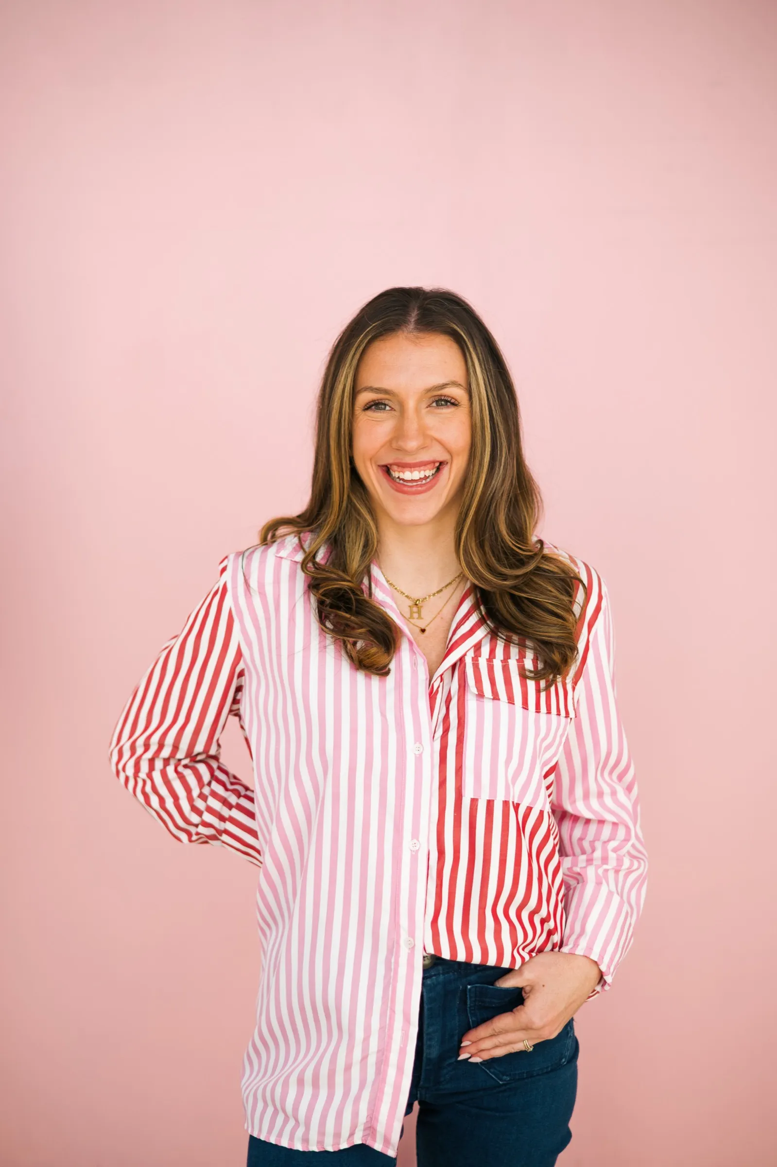 Portrait of Madison Bynum smiling against a soft pink backdrop