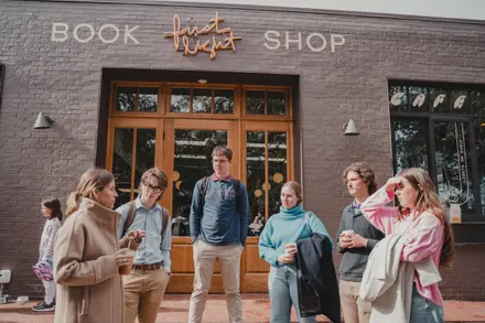 LeapYear students visiting First Light Books with owner Robin Bruce