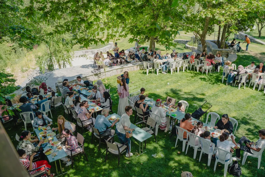 LeapYear students and community members sharing a long outdoor meal in Greece