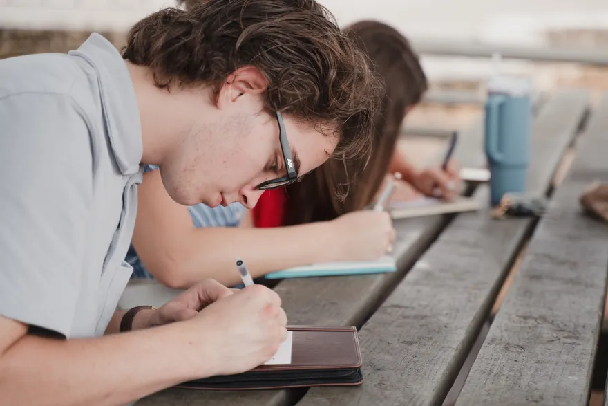A Year One student reflecting in a journal at the retreat